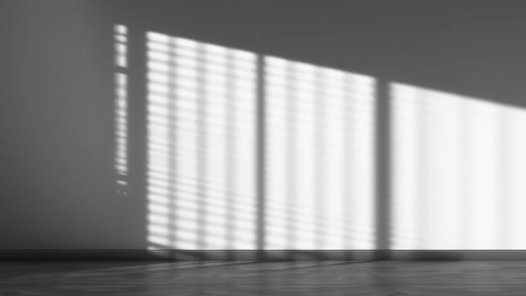 Venetian blind shadow stripes across an empty wall, black and white, abstract concept