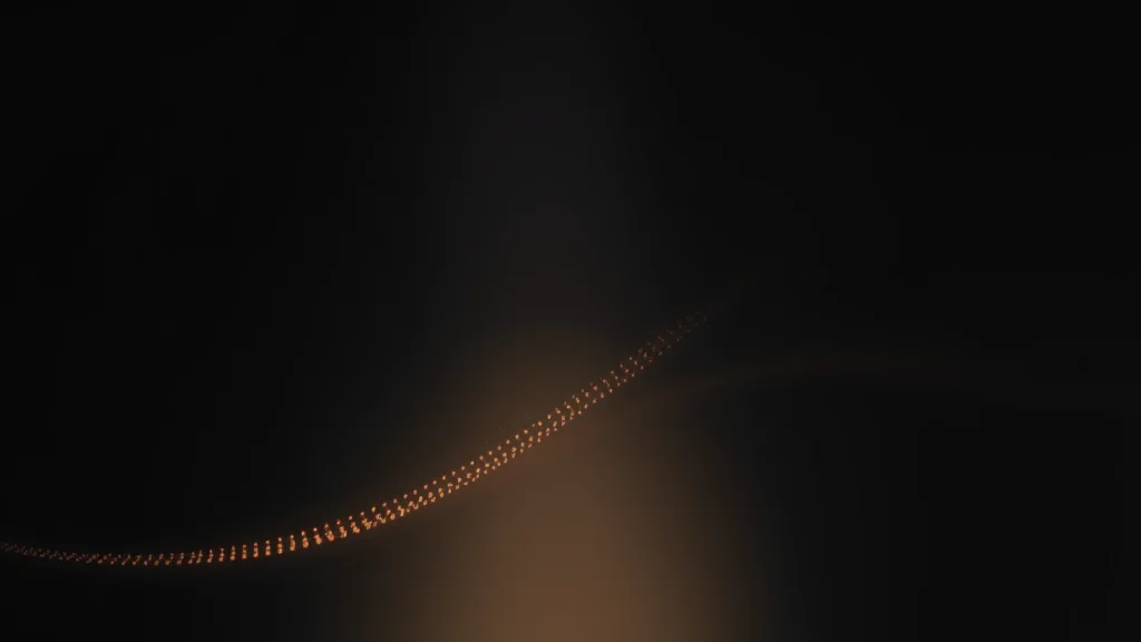 Abstract flowing line of light dots reaching a soft dim wall on dark, editorial concept